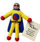 A handmade felt super hero character for use as a gift tag/keepsake. The character is in a yellow outfit, with blue cape. A red 'S' is on the front of their body. The super hero has black hair and a red mask.