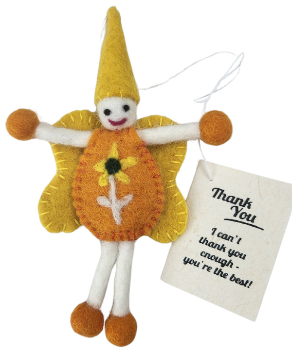 A handmade felt fairy/pixie/gnome keepsake gift tag with a yellow hat and wings, orange body, white limbs, and a 'Thank You' tag attached, on a white background.