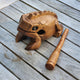 Wooden frog-shaped percussion instrument on a wooden surface