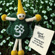 A felt St. Patrick's Day fairy to give you the 'luck of the Irish'? This keepsake has a yellow hat and shoes, green body and wings, and a white shamrock design, hanging outdoors among clover with a 'Good Luck' message/gift tag.