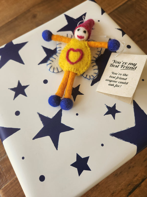 A handmade felt fairy gift tag shown affixed to a present. Displaying "you're my best friend'.