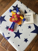 A felt fairy/pixie gift tag shown attached to a present with the "Well Done" gift message.