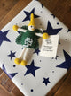 A 'Good Luck' gift tag and keepsake fairy attached to a present.