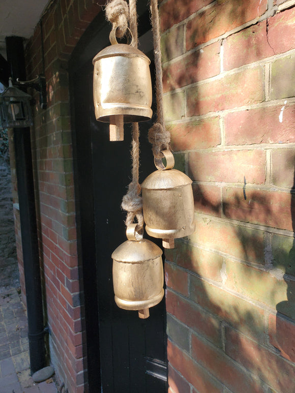 cow bells hanging on a rope