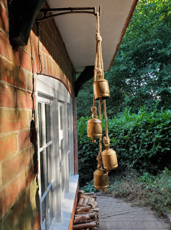 hanging cow bells on a house