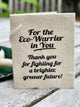 A handmade paper thank you gift tag with black printed text reading 'For the Eco-Warrior in You. Thank you for fighting for a brighter, greener future!'