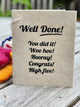 Gift tag with message, "Well Done. You did it! Woo hoo! Hooray! Congrats! High five!"