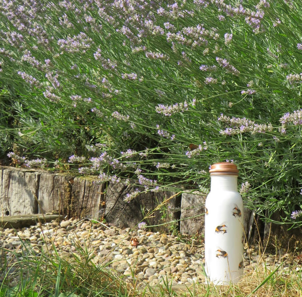 Copper drinking bottle lifestyle shot outside