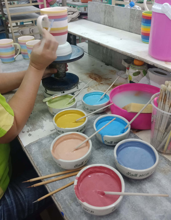 Rainbow striped mug being hand painted